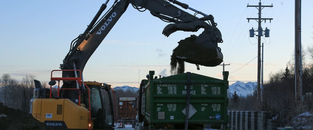 Excavator loading a truck with dirt